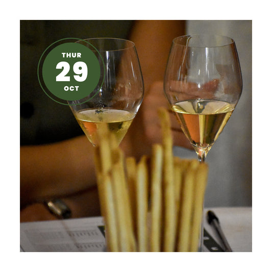 Two clear wine glasses filled with white wine, with breadsticks in the foreground and a green circular date overlay reading 'THUR 29 OCT'.