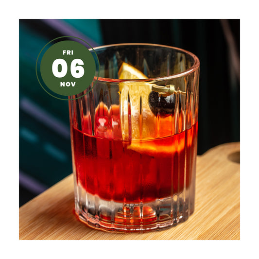 A cocktail glass with a Negroni, with 6th November date written for a masterclass