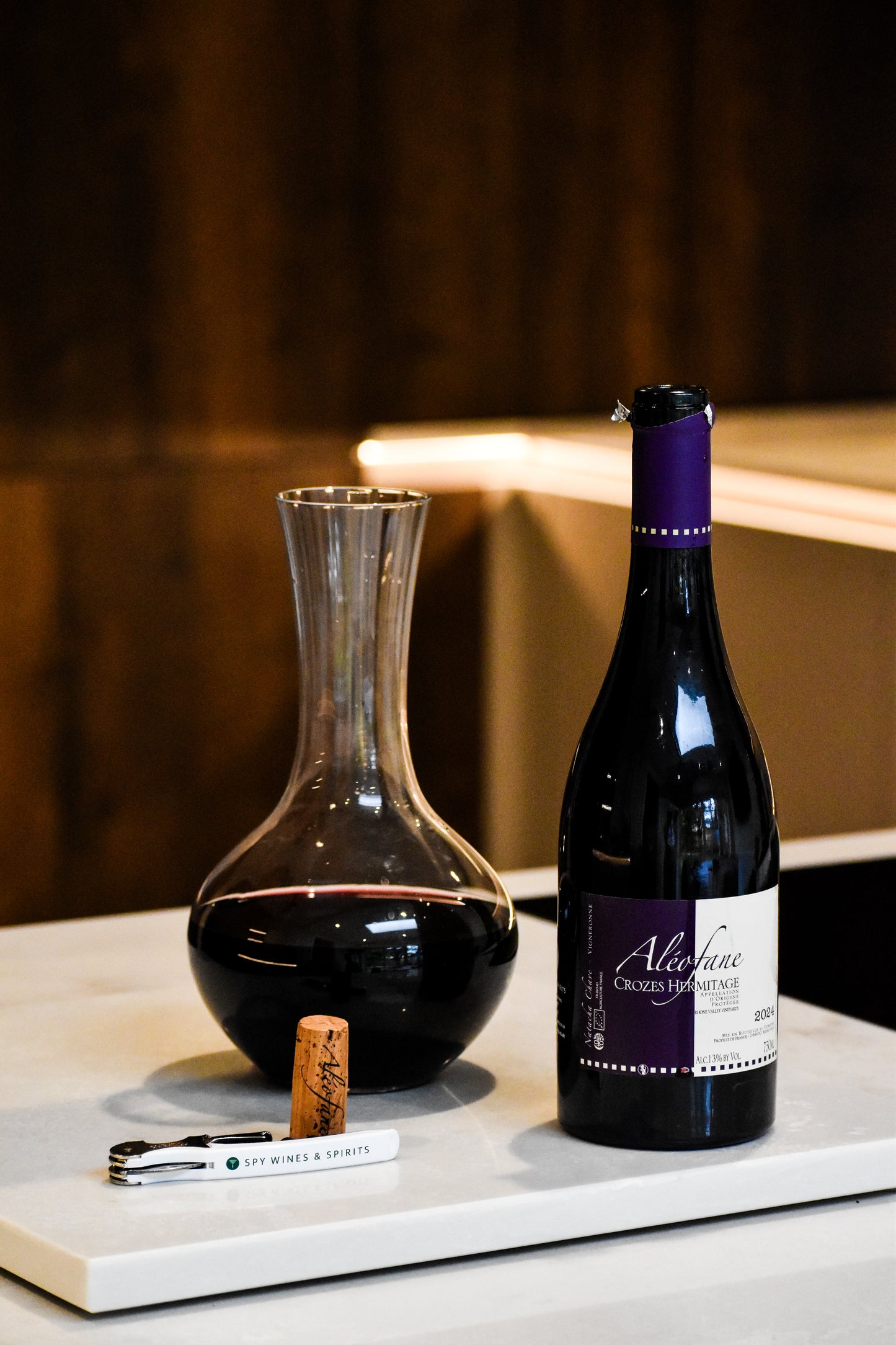 Aleofane Crozes Hermitage Rouge with decanter and corkscrew in wood kitchen
