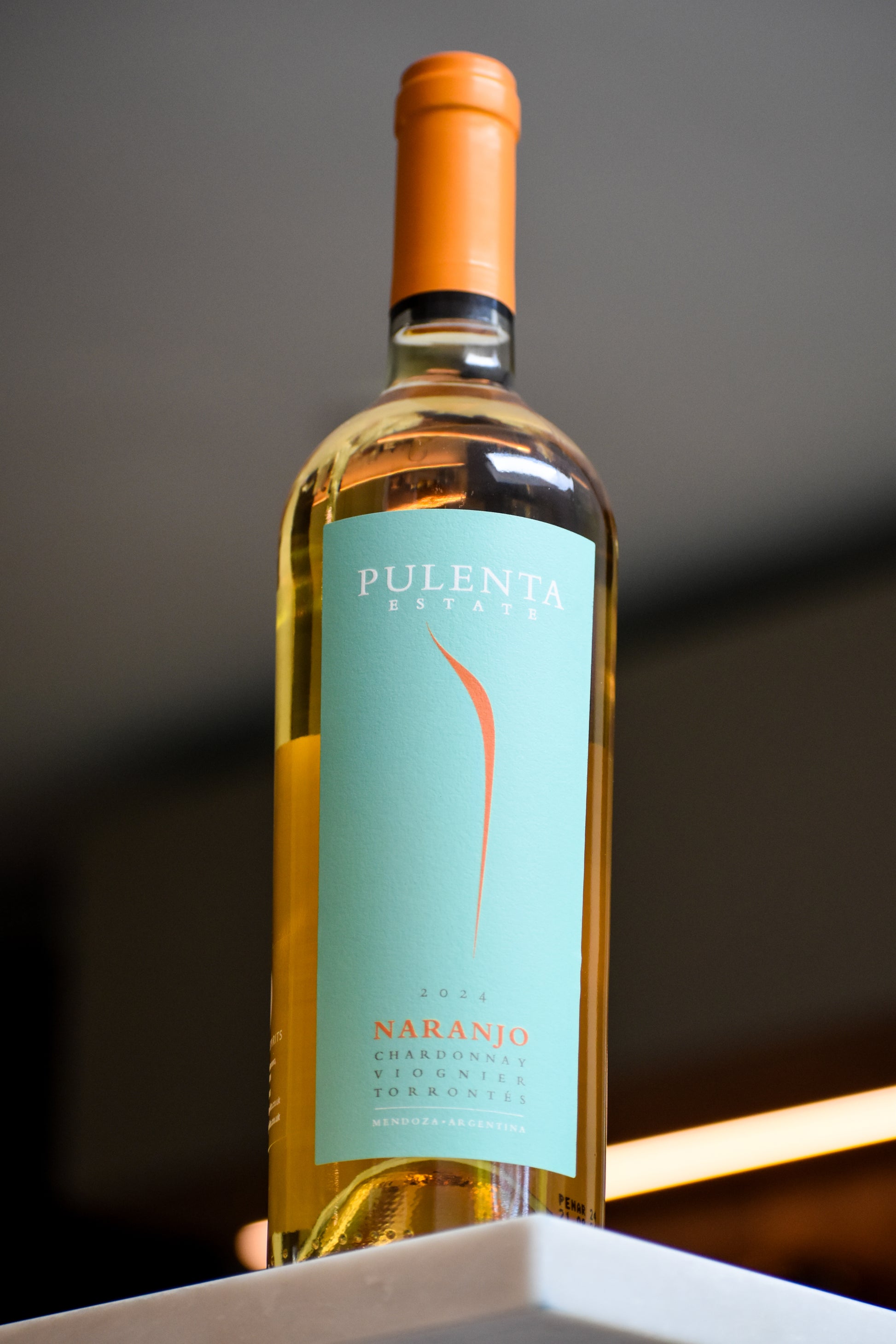 Wine bottle with a green label on a dark background