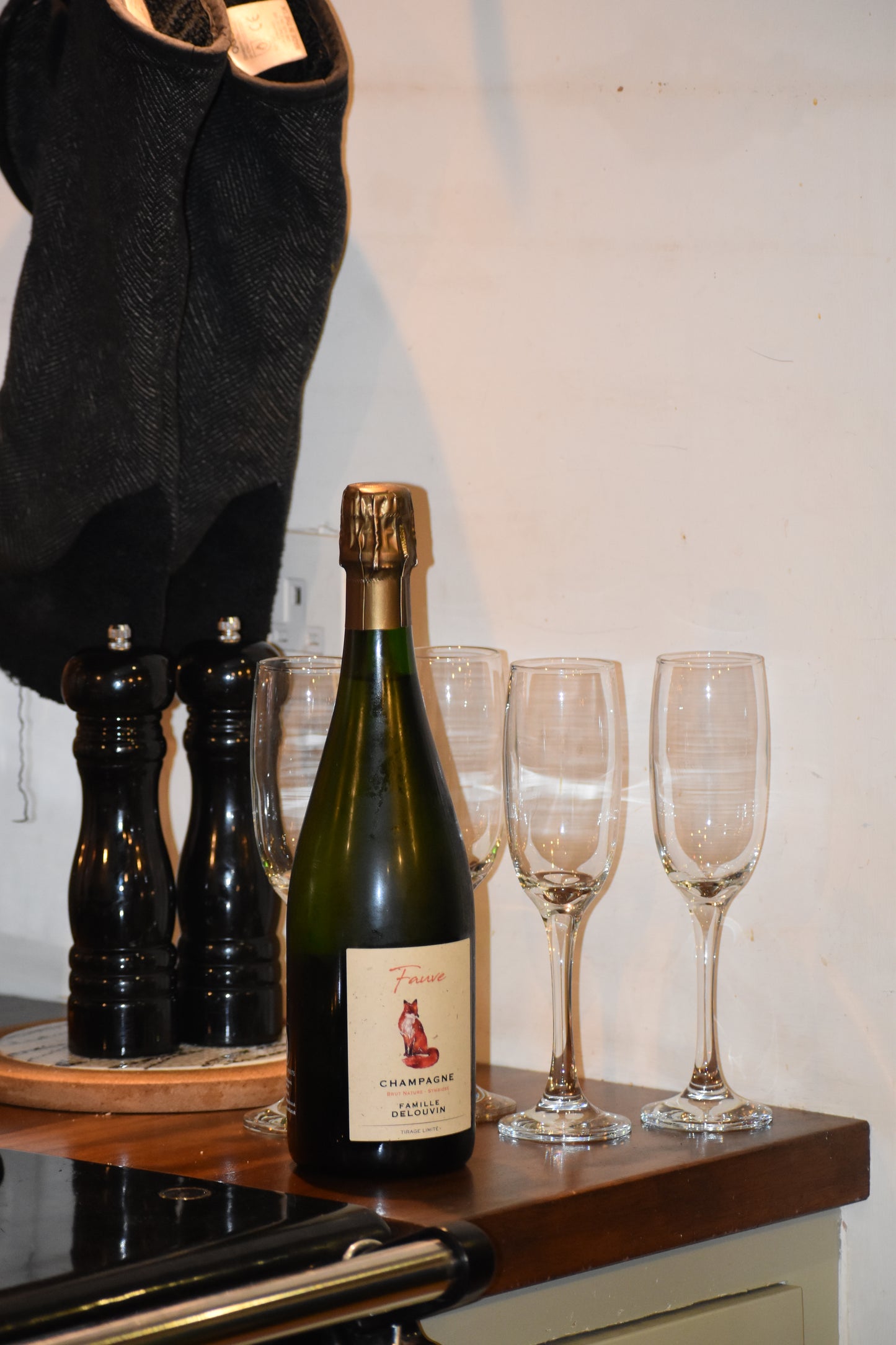 Champagne bottle next to stove in kitchen