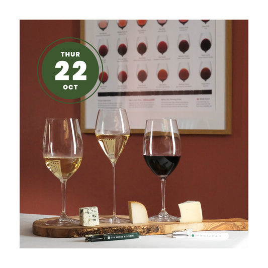 Three wine glasses filled with white, pale, and red wine on a wooden serving board with cheese wedges, set against a warm brown wall with a framed wine color chart. A green circular badge in the top left reads 22 October