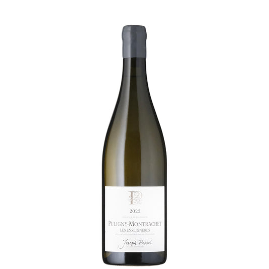A bottle of Joseph Pascal Puligny Montrachet white wine with a label featuring a logo, P with vines flowers intertwined.