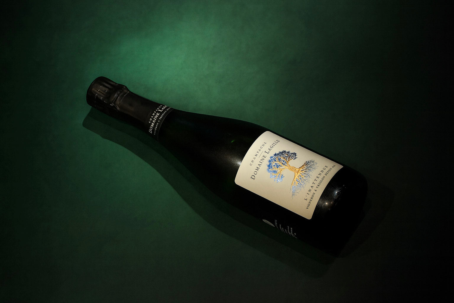 Domaine Lagille L'inattendue Champagne with tree on label on dark green background
