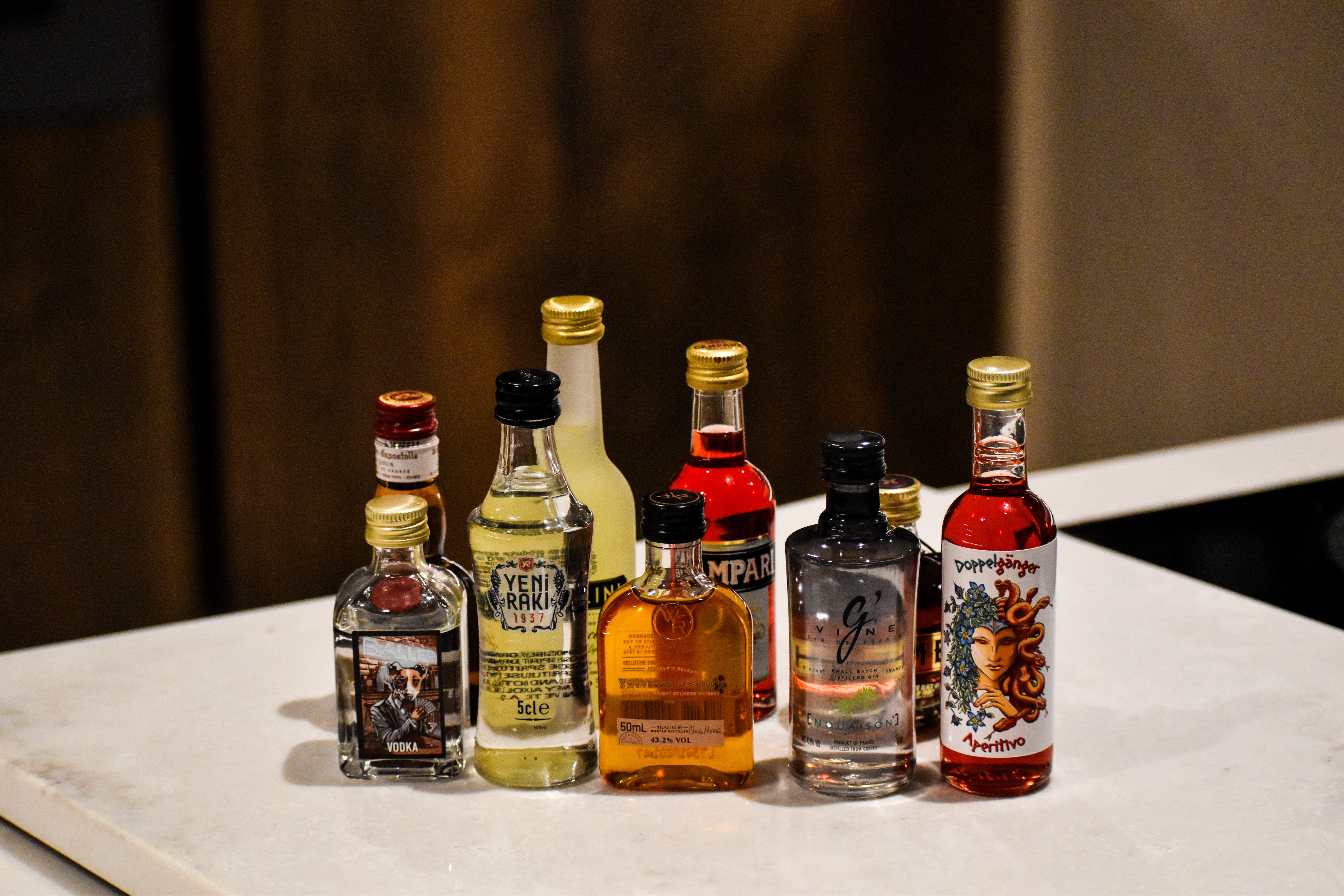Collection of various mini bottles on a marble surface